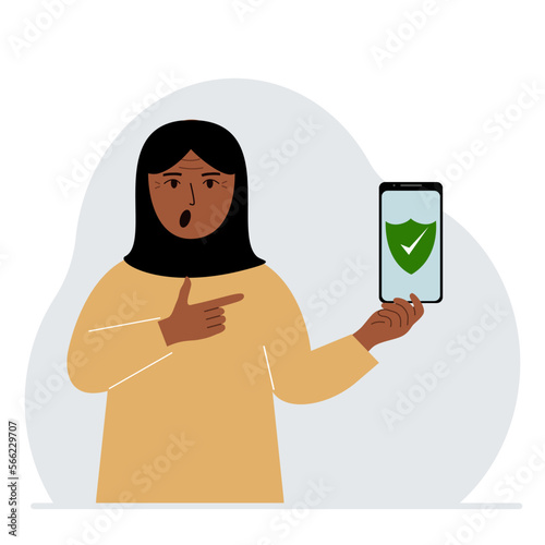 A woman holds in his hand a mobile phone on which antivirus software is installed.