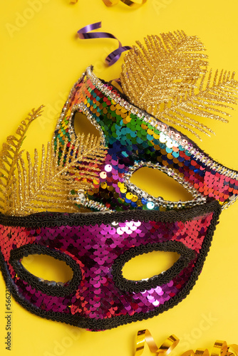 Festive face mask for carnival celebration or masquerade on colored background
