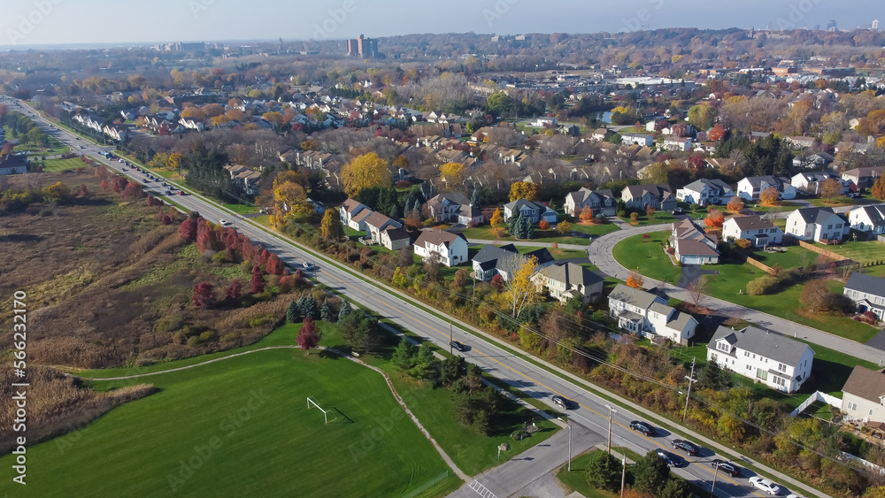 Aerial view Westfall Road along residential neighborhood and soccer field park in Monroe County, Rochester, Upstate New York
