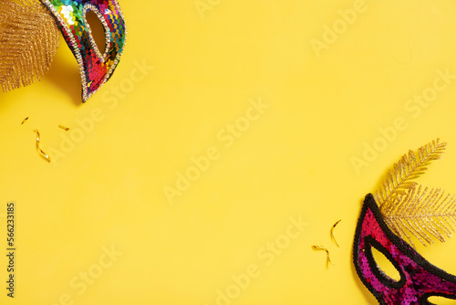 Festive face mask for carnival or masquerade celebration on colored background with copy space