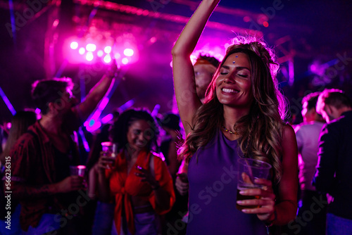 Caucasian woman dancing at concert