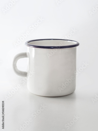 White and black enamelled metal vintage mug