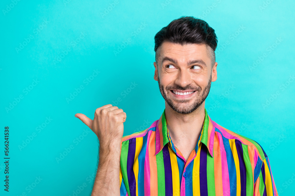 Photo of handsome positive funny man brunet hair dressed striped shirt look directing empty space isolated on turquoise color background Photo of handsome positive funny man brunet hair dressed striped shirt look directing empty space isolated on turquoise color background