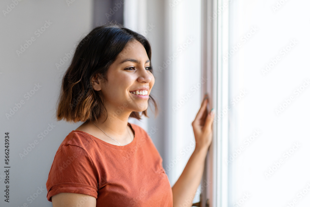 Portrait Of Beautiful Young Arab Woman Standing Near Window At Home Portrait Of Beautiful Young Arab Woman Standing Near Window At Home