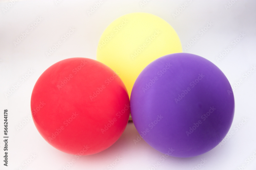 Three inflated balloons with the red, yellow and purple colors of the republican flag in Spain Three inflated balloons with the red, yellow and purple colors of the republican flag in Spain
