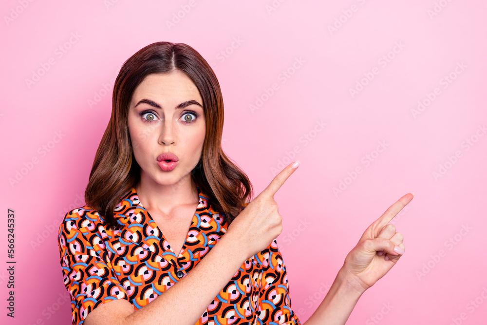 Photo portrait of pretty young girl impressed plump lips point empty space dressed stylish print outfit isolated on pink color background Photo portrait of pretty young girl impressed plump lips point empty space dressed stylish print outfit isolated on pink color background
