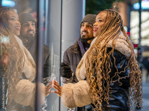 Smiling young couple window shopping photo