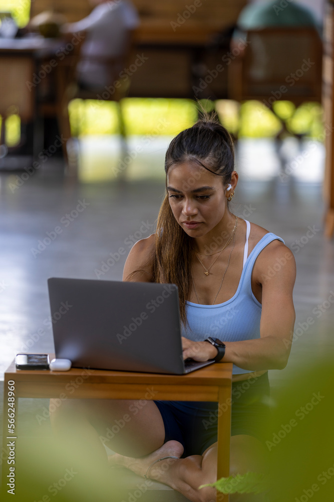 Woman sitting in hotel lounge and using laptop Woman sitting in hotel lounge and using laptop
