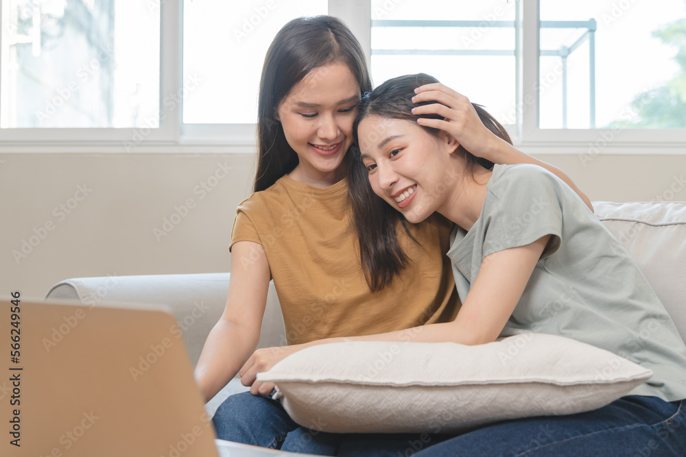 two happy women lesbian couple watching series on internet via touchpad relax together. two happy women lesbian couple watching series on internet via touchpad relax together.