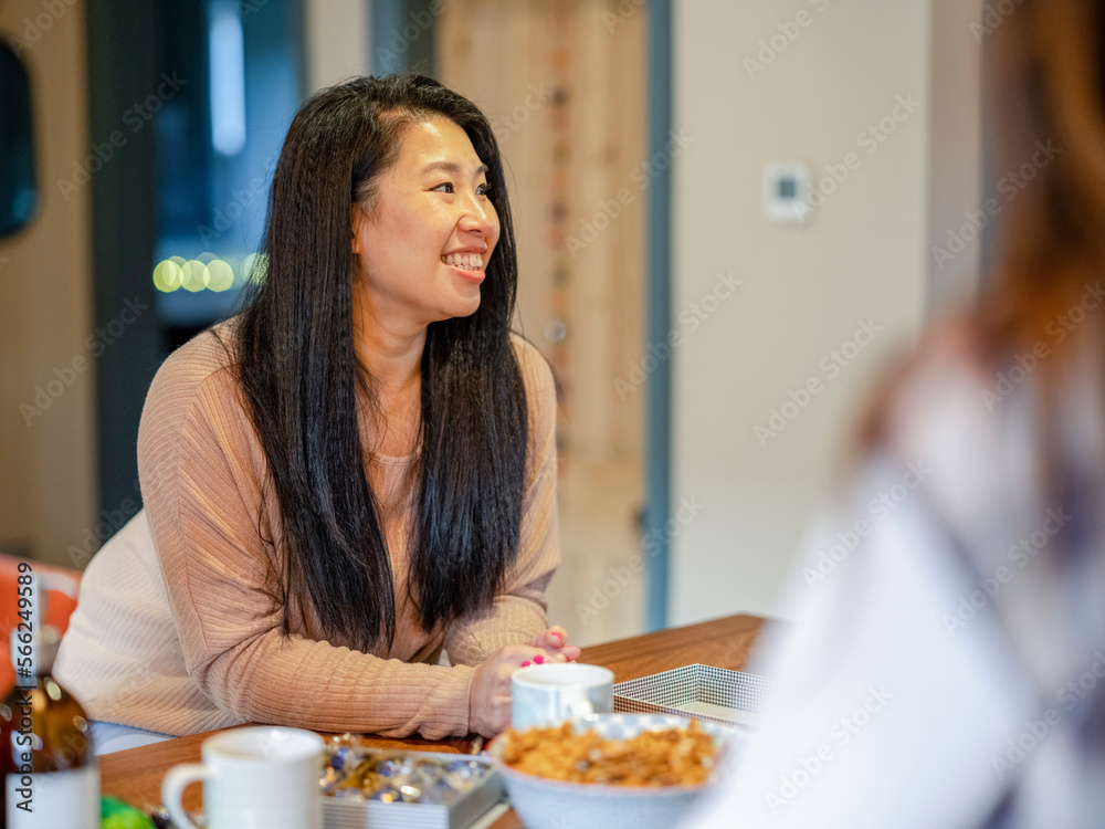 Female friends talking in kitchen Female friends talking in kitchen