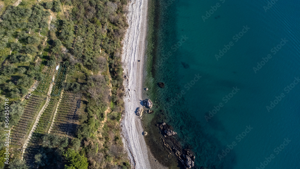 Fantastic landscape taken from the drone at the top of the cliff. Trieste, Italy. Clear sea and blue sky. Rocks and sand.