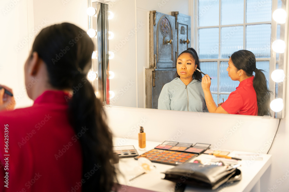 Fototapeta premium Woman getting make up in front of mirror at spa