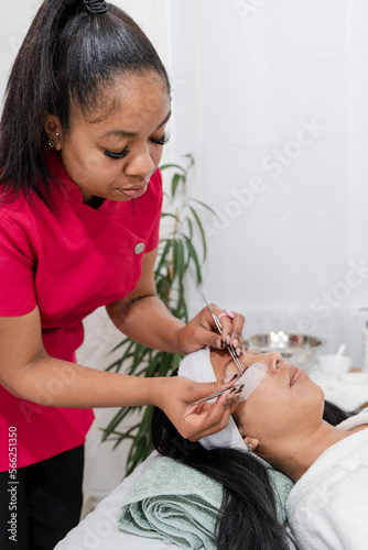 Woman having eyelash extension at spa