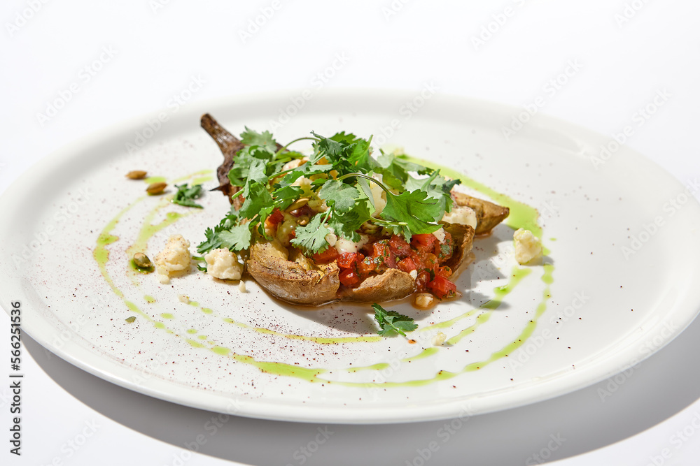 Baked eggplant with cheese on white table with harsh shadows. Aesthetic italian food - baked aubergine on white plate. Stuffed eggplant in minimal style. Stuffed aubergine in vegan menu. Baked eggplant with cheese on white table with harsh shadows. Aesthetic italian food - baked aubergine on white plate. Stuffed eggplant in minimal style. Stuffed aubergine in vegan menu.