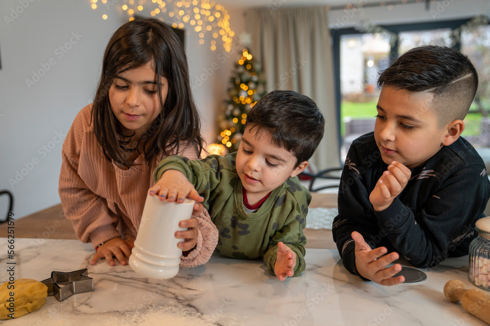 Kids preparing Christmas cookies in kitchen Kids preparing Christmas cookies in kitchen
