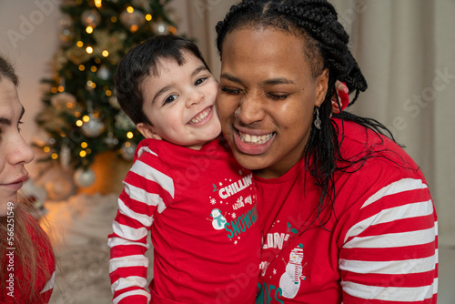 Christmas portrait of smiling moms with son at home