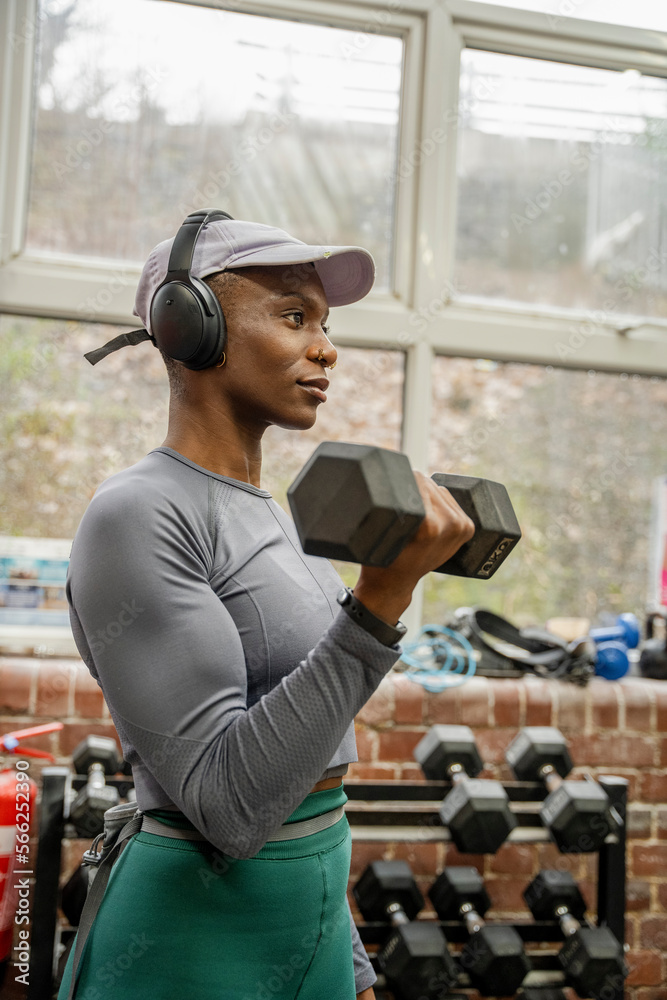 Woman exercising with dumbbells at gym Woman exercising with dumbbells at gym