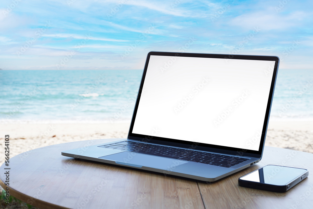 Hands using laptop computer with beautiful beach background Hands using laptop computer with beautiful beach background