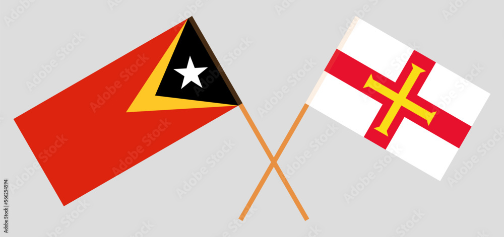 Crossed flags of East Timor and Bailiwick of Guernsey. Official colors. Correct proportion