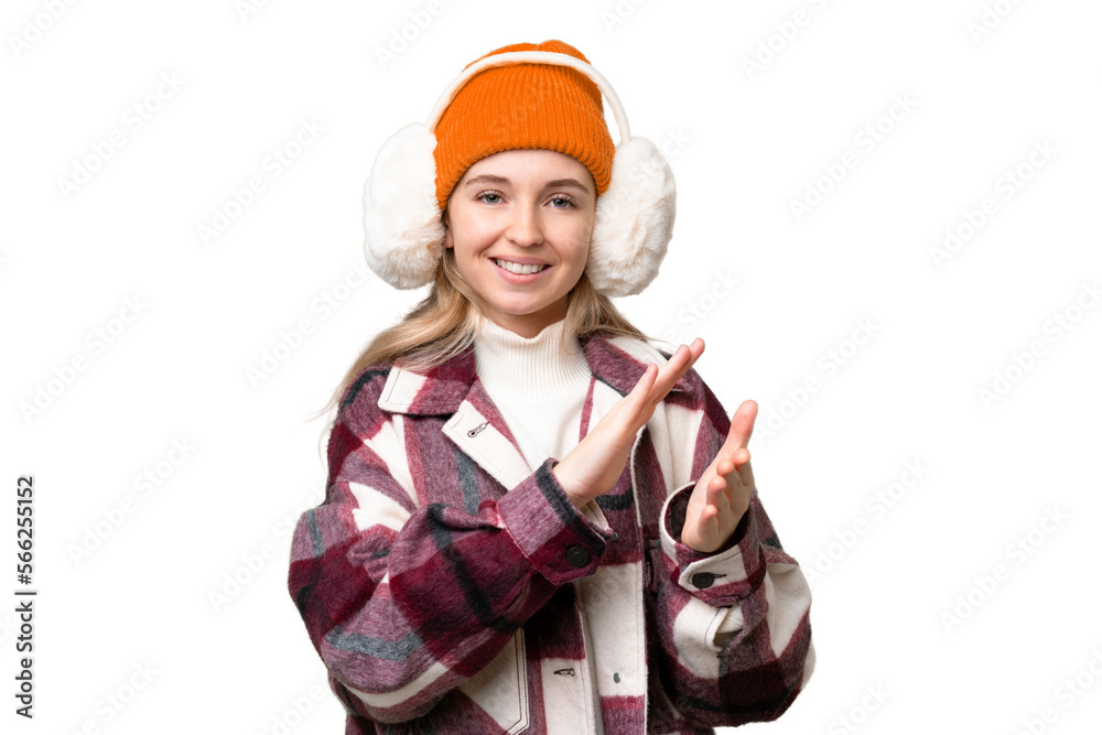Young  English woman wearing winter muffs over isolated background applauding after presentation in a conference