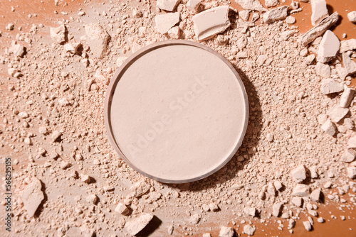 Obraz na plátně Crushed face powder and round box of pressed one on top on brown background