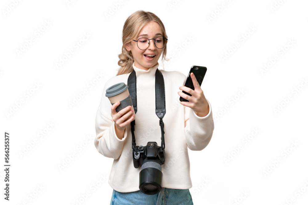 Young photographer English woman over isolated background holding coffee to take away and a mobile