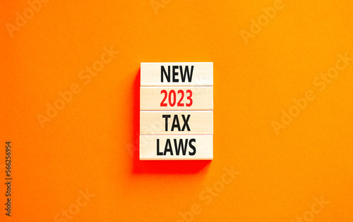New 2023 tax laws symbol. Concept words New 2023 tax laws on wooden blocks. Beautiful orange table orange background. Business new 2023 tax laws concept. Copy space.