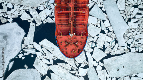 An orange-coloured tanker passes through thick ice in search of an icebreaker that will guide tankers through the arctic ice photo