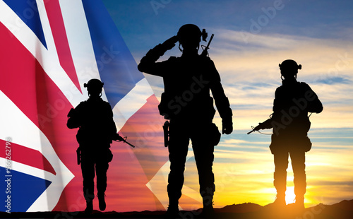 Silhouettes of a soldiers with United Kingdom flag on background of sky. Background for Remembrance Day. United Kingdom Armed Forces concept. EPS10 vector