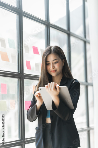 Pretty asia business woman bookkeeper brainstorming and working in modern office workplace with sticky notes or post it at windows. Free Download Pretty asia business woman bookkeeper brainstorming and working in modern office workplace with sticky notes or post it at windows. - GFXLoad