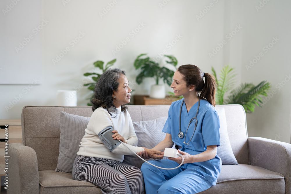 Female doctor measuring senior woman's blood pressure at home. Female doctor measuring senior woman's blood pressure at home.