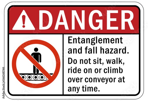 machine hazard sign and labels entanglement and fall hazard. Do not sit, walk, ride or climb over conveyor at any time