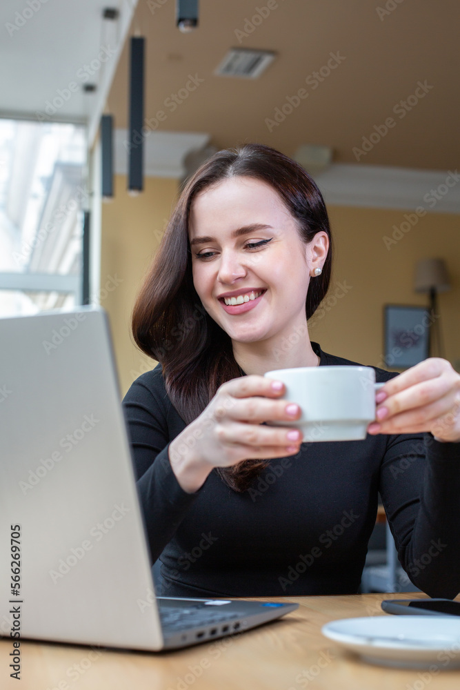 Beautiful businesswoman working on laptop in coffee shop. Female freelancer connecting to internet via computer. Blogger or journalist writing new article. Beautiful businesswoman working on laptop in coffee shop. Female freelancer connecting to internet via computer. Blogger or journalist writing new article.