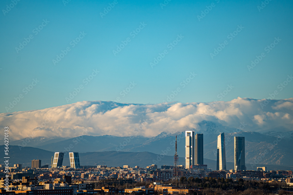 City of Madrid with the towers of Castellana street and the Navacerrada mountain with snow.