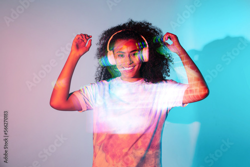 Cheerful black woman listening to music at studio