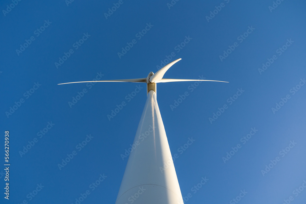 Wind turbine against blue cloudless sky