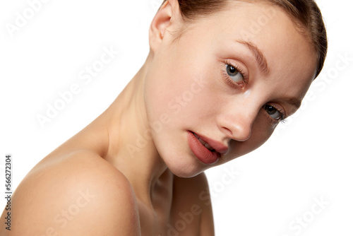 Half-length portrait of young beautiful girl without makeup on face. Model with bare shoulders. Concept of purity, skin care, beauty, spa, anti-aging procedures