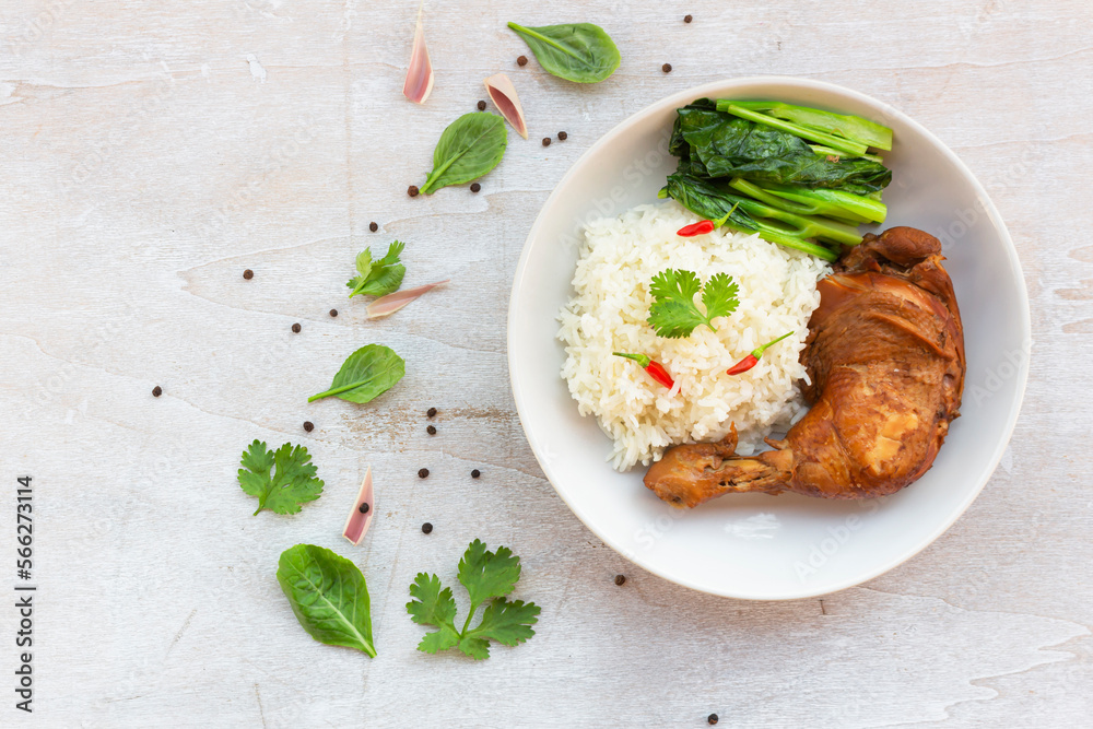 Healthy food chicken braised has rice kale garlic chili sauce in plate on white wood table. Healthy food chicken braised has rice kale garlic chili sauce in plate on white wood table.