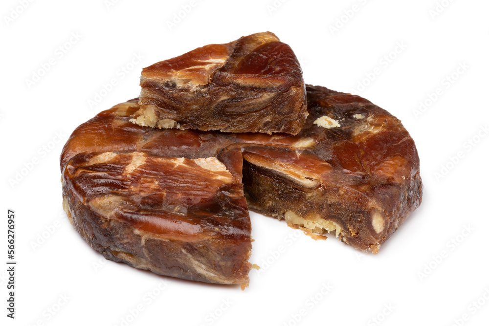 Round date bread with walnuts and a piece isolated on white background