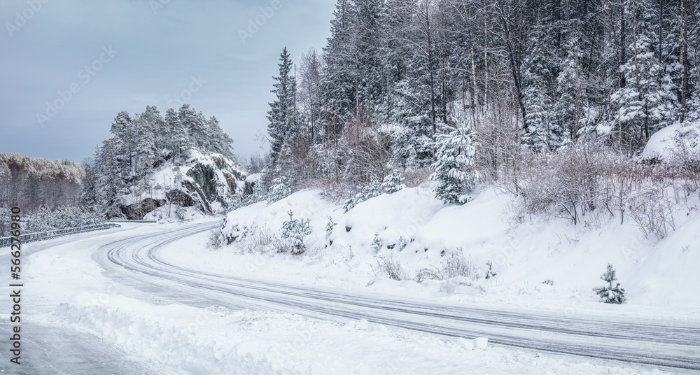 Slipery country road in snowy forest in winter. No cars.Bad driving conditions. Scandinavia. Slipery country road in snowy forest in winter. No cars.Bad driving conditions. Scandinavia.