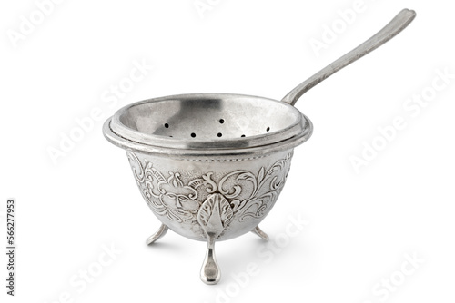Antique old fashion silver tea strainer and stand on white background photo