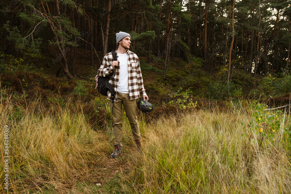Young active man tourist hiking in beautiful forest Young active man tourist hiking in beautiful forest