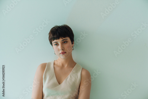 Beautiful short-haired woman posing while standing indoors