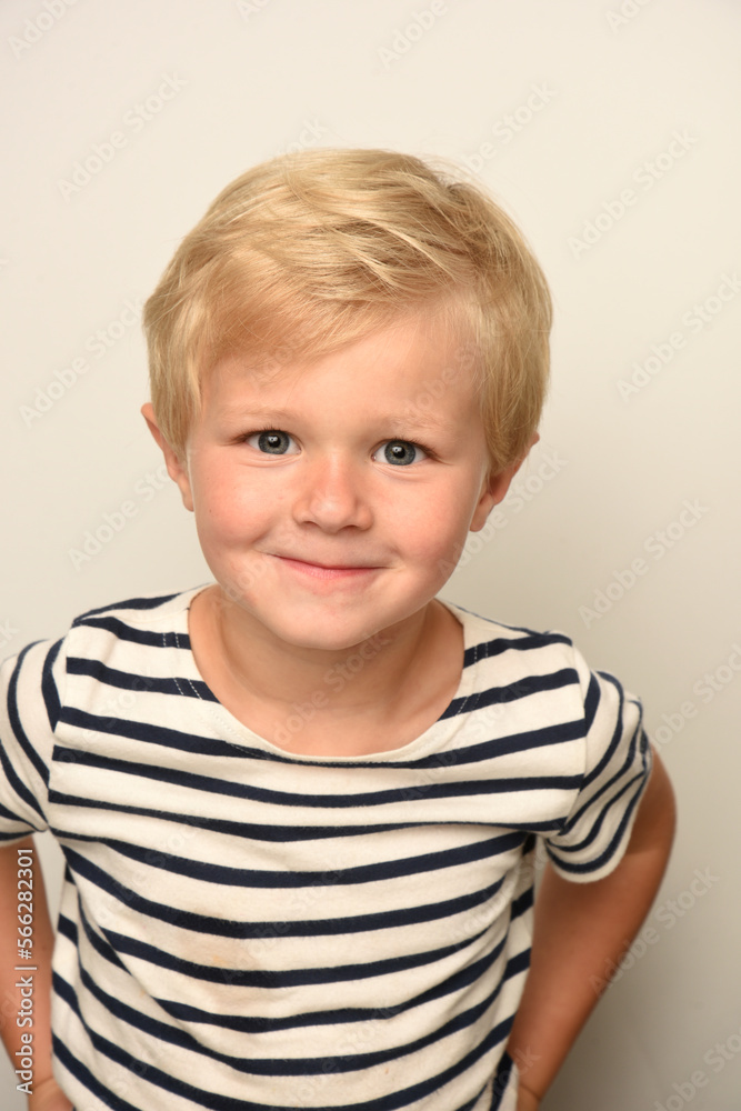 young blond child smiling with a striped sailor young blond child smiling with a striped sailor