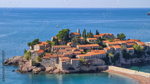 Panoramic view of idyllic island Sveti Stefan in Bay of Budva, Adriatic Mediterranean Sea, Montenegro, Europe. Summer vacation in exclusive luxury hotel complex resort at the seaside. Medieval town