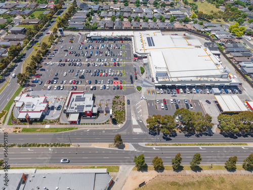Aerial view of a large shopping centre and carpark on a busy major road photo