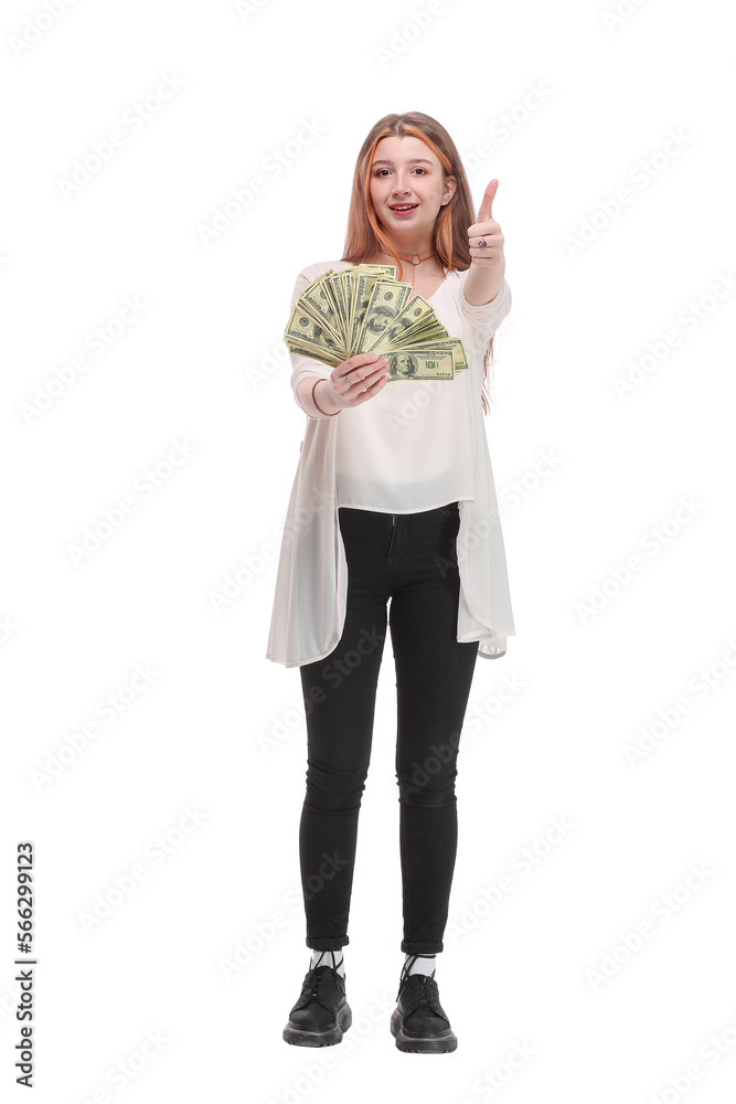 Beautiful successful young woman shows a thumb up and holding the money, american dollars. Beautiful successful young woman shows a thumb up and holding the money, american dollars.