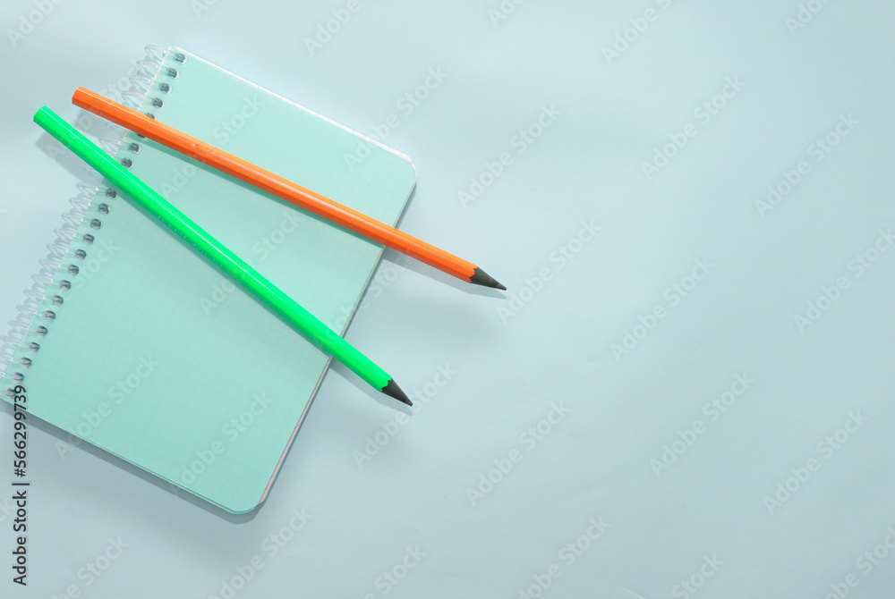 Top view blank notepad with colored pencils copy space. Top view blank notepad with colored pencils copy space.