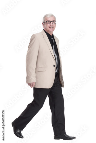 intelligent mature man in a white jacket walking forward .
