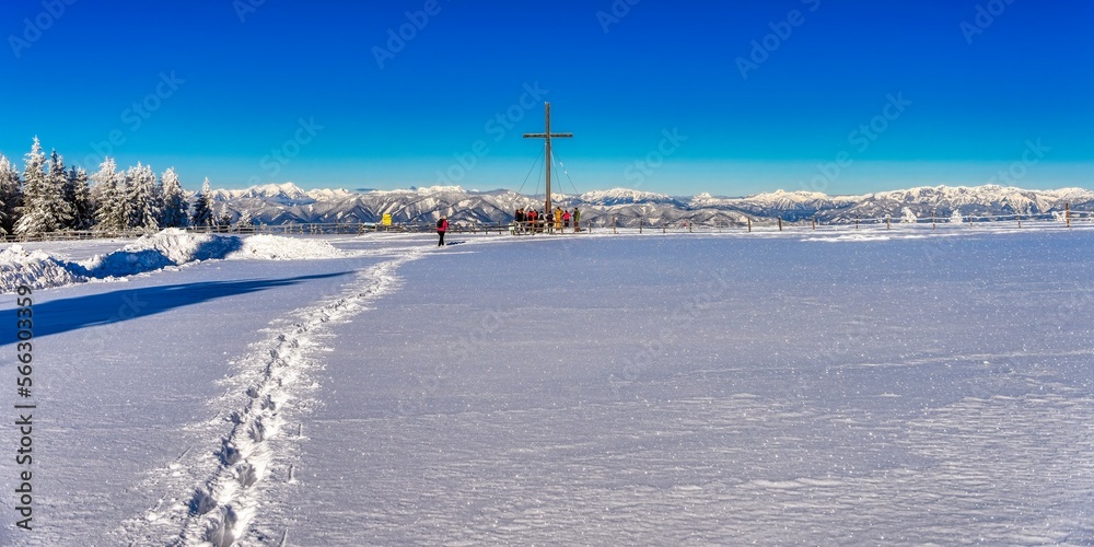 landscape with snow and peak cross